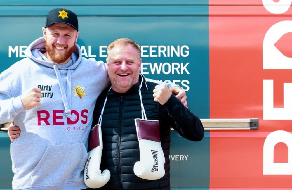 REDS CEO Lloyd Burnard and heavyweight boxer Harry Armstrong