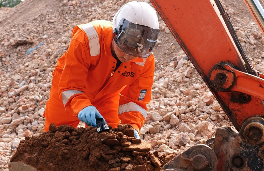 REDS employee collecting soil samples
