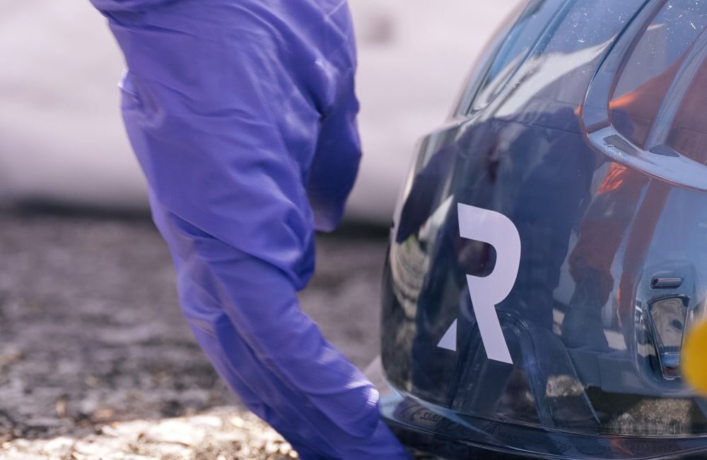 REDS employee picking up protective helmet
