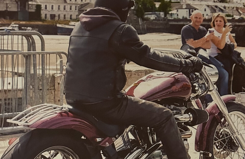 Les riding his Harley Davidson.