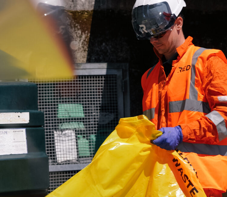 REDS employee safely bagging up hazardous material