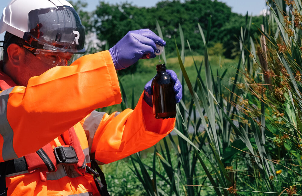 REDS employee collecting a water sample