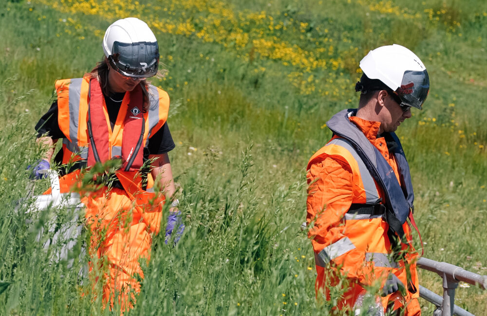Two REDS employees walking through a field
