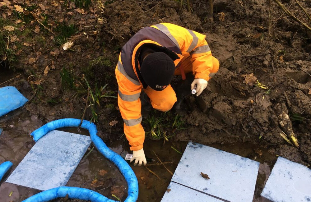REDS engineer taking samples from spill